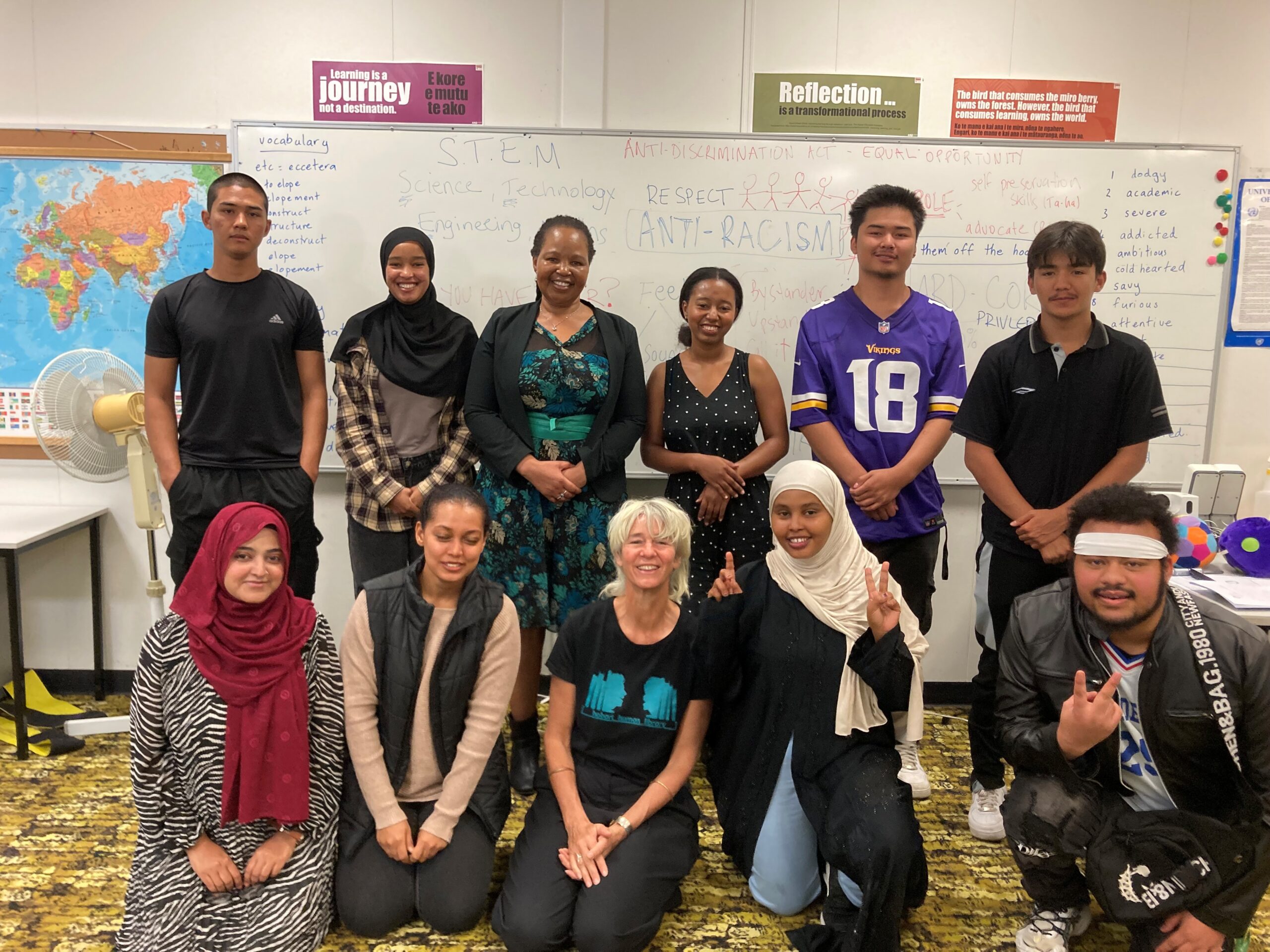 Students Against Racism students with A Fairer World Staff and human book