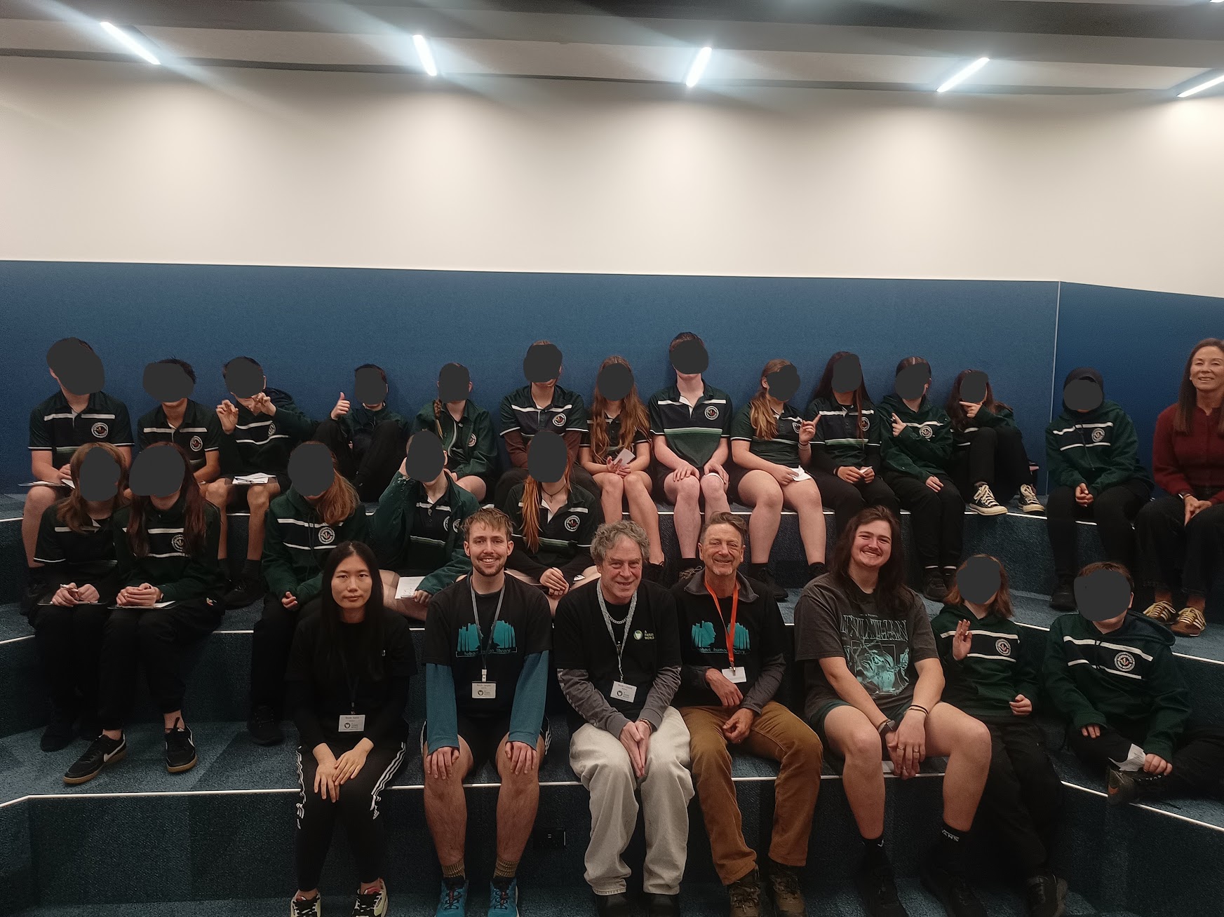 Devonport High School students and staff with A Fairer World's human 'books' Katie, Jasper, David, and Paul.